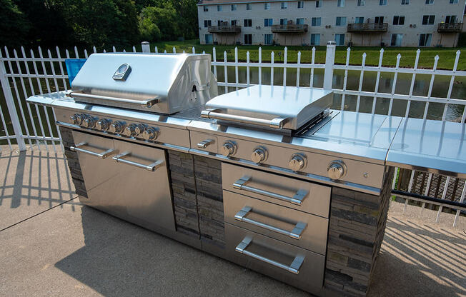 a stainless steel grill and barbecue on a patio
