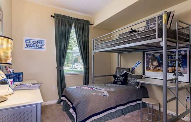 A bedroom with a bunk bed and a poster of Clone Wars.