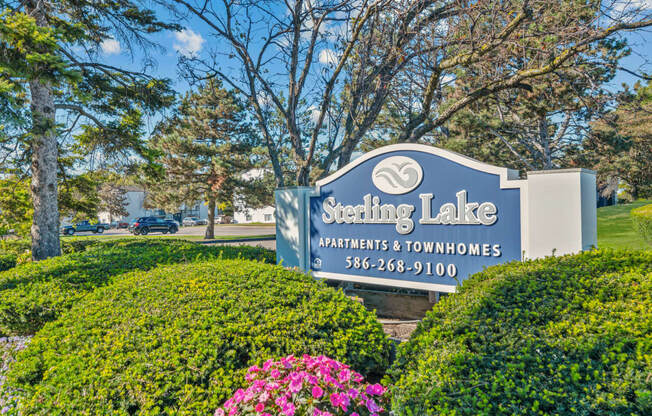 a sign for setting lake apartments  townhomes with flowers