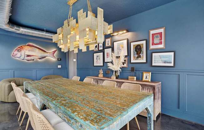 A dining room with a long table and chairs.