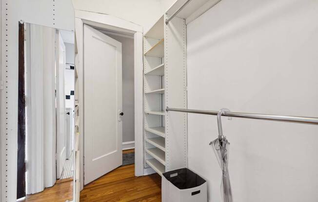a room with a closet and a trash can in it at The Bryant at Oak Park I & II, Oak Park, IL 60302