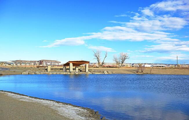 a sandy beach next to a body of water