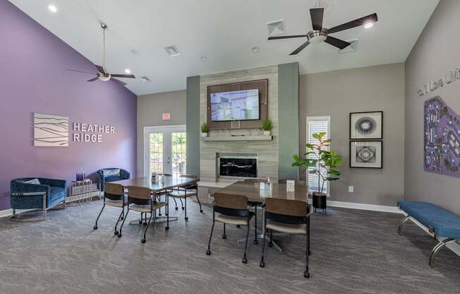 a living room with a table and chairs and a fireplace