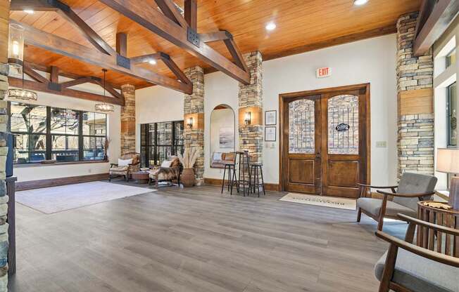 A large room with wooden floors and a stone wall.