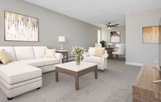 a living room with white couches and a coffee table