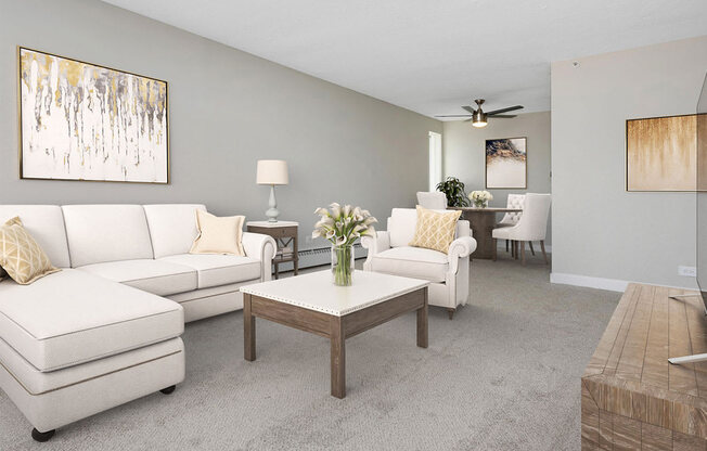 a living room with white couches and a coffee table