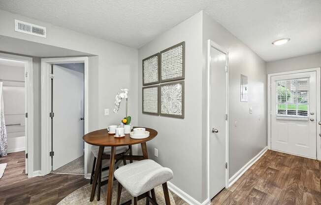 A dining area with a table and chairs.
