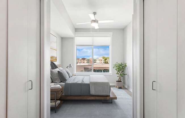 Model Bedroom with Carpet and Window View at Seven Skies Apartments located in Sandy, UT.