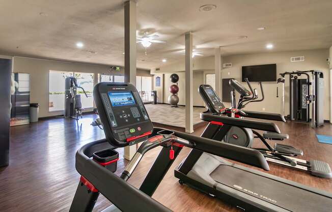 24-hour fitness center with a variety of equipment including treadmills, eliptical,and exercise balls at Princeton Court Apartments in the Vickery Midtown neighborhood of Dallas, TX.