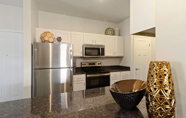 Ashland Farms Kitchen with Spacious Counters and White Cabinetry with Modern Fixtures