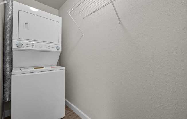 a small laundry room with a washer and dryer and a white dryer