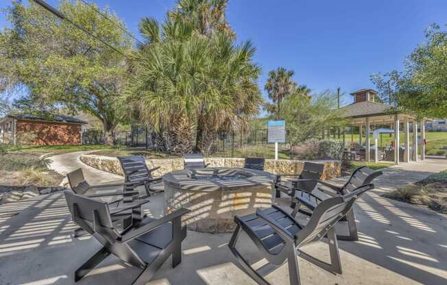 a group of chairs around a patio with a fire pit  at Sunset Ridge, San Antonio, TX