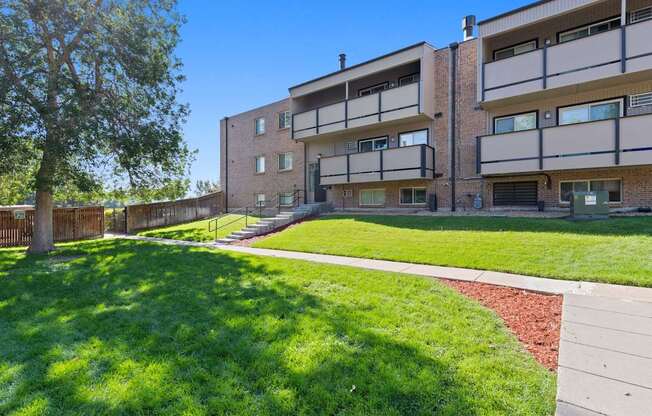 Apartment building with a green lawn in front.