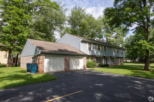 the front of a house with a garage and a driveway