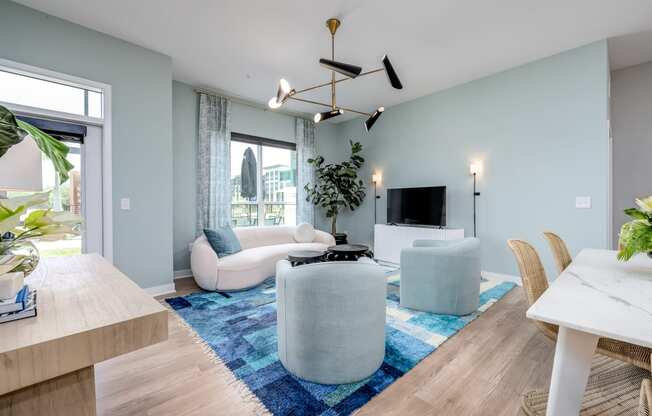 a living room with light blue walls and a blue rug