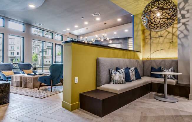 A modern living room with a yellow accent wall and a large window.