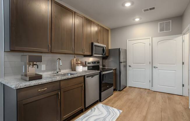 a kitchen with stainless steel appliances and wooden cabinets