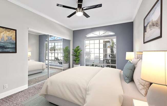 Carpeted bedroom featuring beautiful natural lighting and ceiling fan.