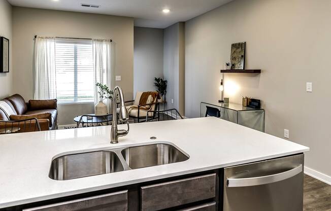 Kitchen with large sink and dishwasher at Hanover Flats in Bennington, NE