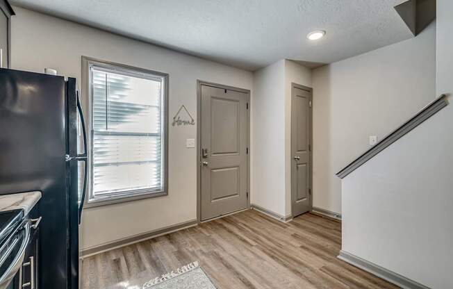 the kitchen and living room of a house with a window and a door
