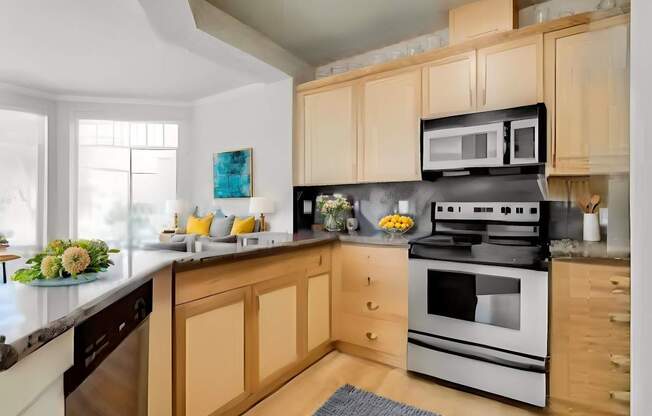 A kitchen with wooden cabinets and a black stove top oven.