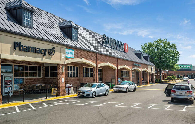 the front of a pharmacy with cars parked in a parking lot