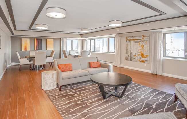 a living room and dining room with couches and a table