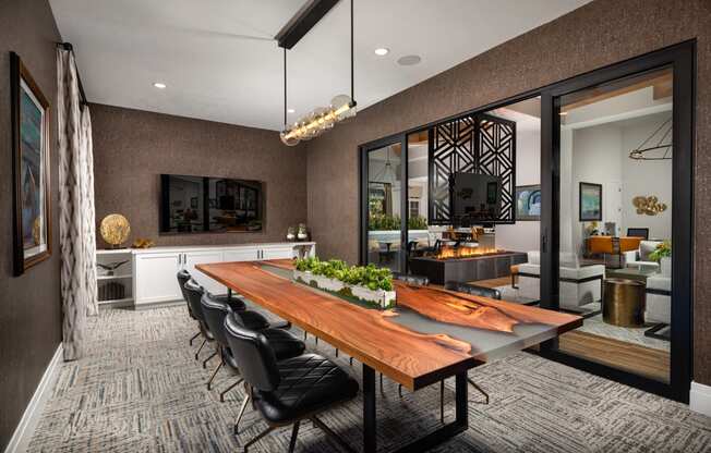 a dining room with a wooden table and black chairs