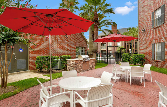 a patio with tables and chairs and umbrellas