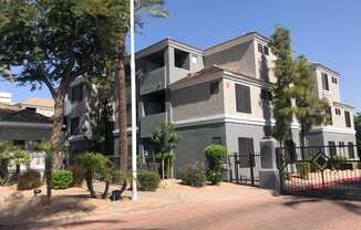 Ingleside apartment building with beige and grey paint and gated entrance