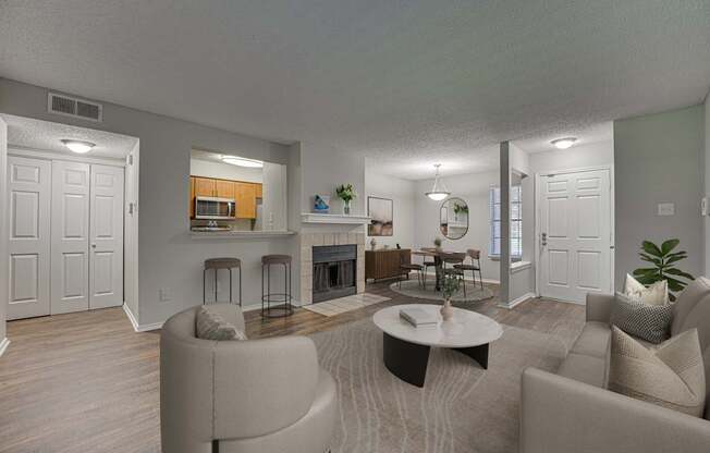 A living room with a fireplace and a dining area.