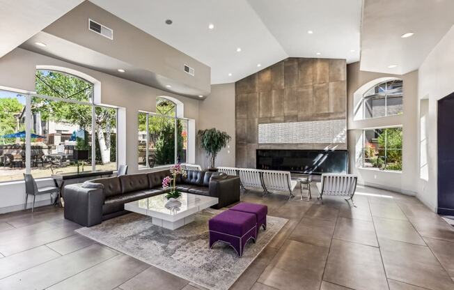 the living room has a large stone fireplace and leather furniture