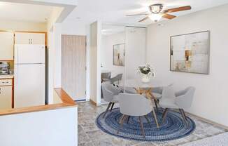 A modern dining room with a white table and chairs.