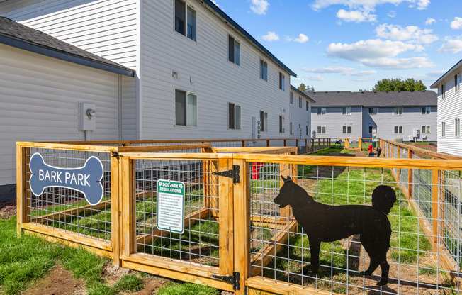 a black sheep in a fence in front of a house