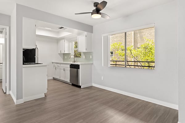 an empty kitchen with a large window and a sinkat NOHO GALLERY Apartments, California