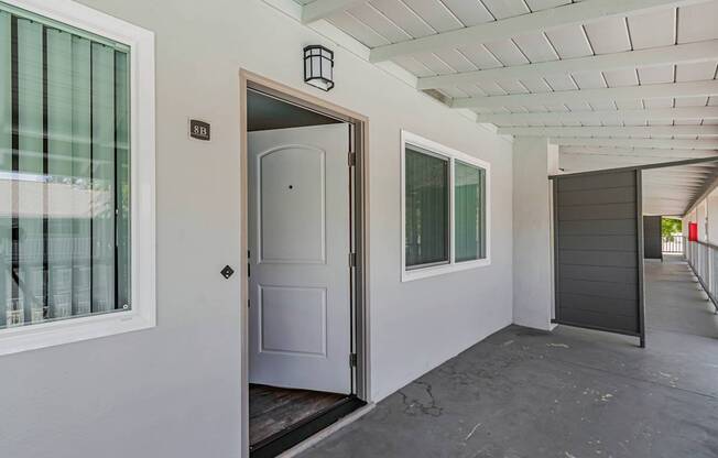 A white door is open to a balcony.