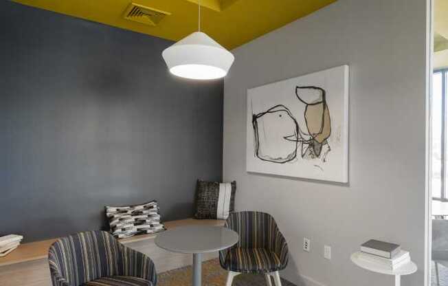 a dining room with a yellow ceiling and gray walls