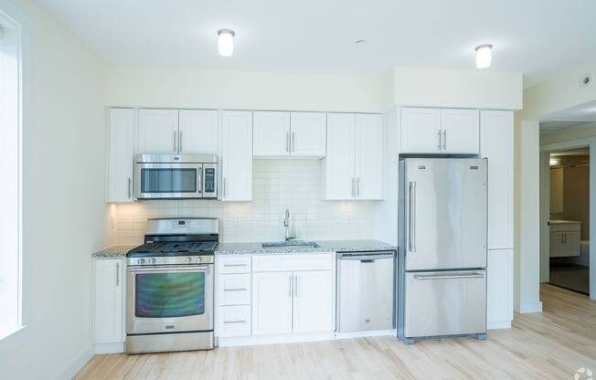 A kitchen with white cabinets and stainless steel appliances at 603 Concord Apartments, Cambridge, Massachusetts