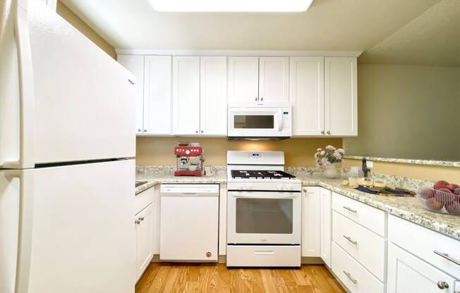 Kitchen With White Cabinetry And Appliances at Carrington Apartments, Fremont, California