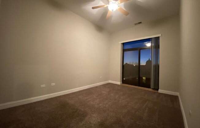 Bedroom with plush carpeting and private patio access - 3 Bedroom