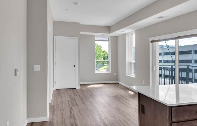 A spacious room with a large window and a door.