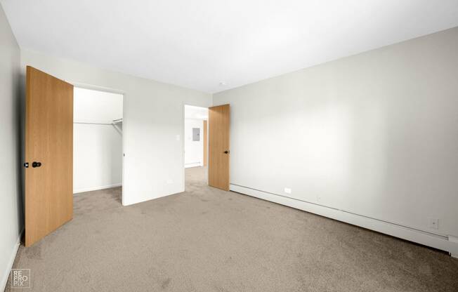 a bedroom with a carpeted floor and white walls