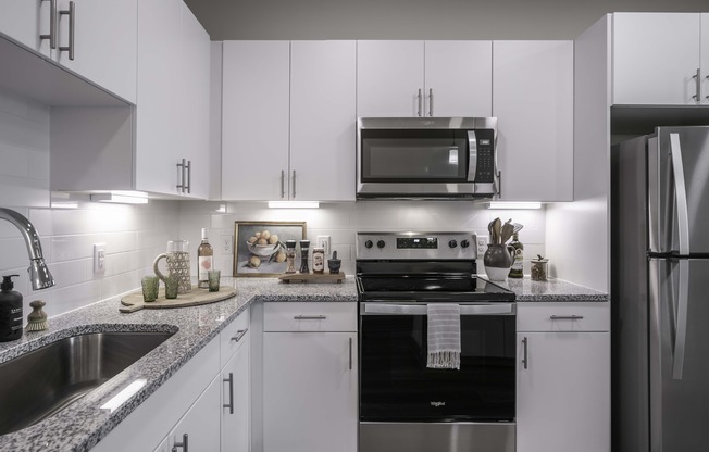 Kitchens with stainless steel appliance package, single-basin sink with pull-down faucet, and stylish tile backsplash.