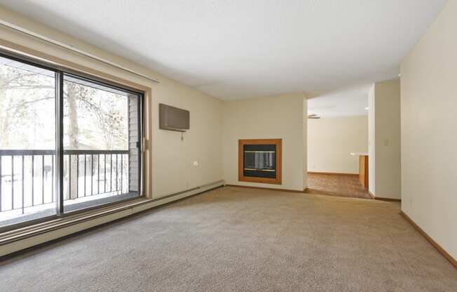 Anoka, MN Dellwood Estates Apartments. a living room with a fireplace and a large window