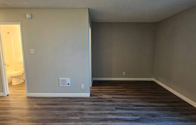 A room with a toilet visible through the open door.