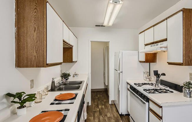 galley style kitchen with oven and dishwasher at mesa gardens apartment