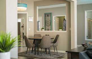 A dining room with a table and chairs at West Park Apartments, Albuquerque