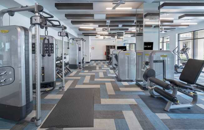 a large fitness room with cardio machines and weights at The Hendrix, Georgia, 30329