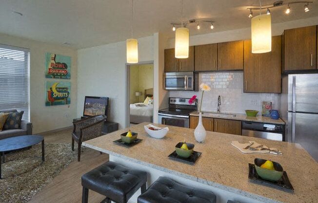 a kitchen and living room with a table and chairs