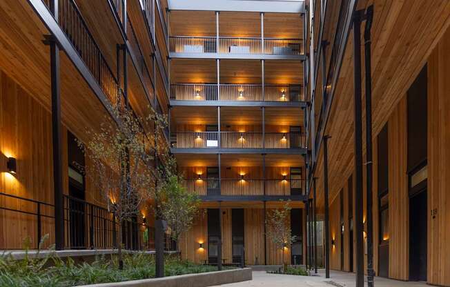 a large building with wooden walls and floors and a sidewalk